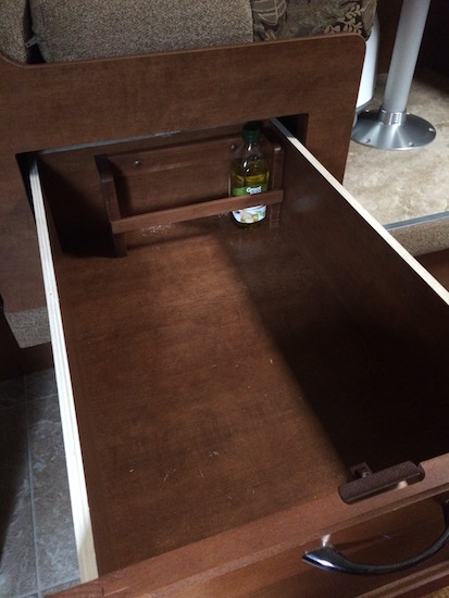 The "other half" of the original magazine rack was attached to the back of the dinette drawer to provide secure space for olive oil and other stuff I don't want sliding around the drawer.